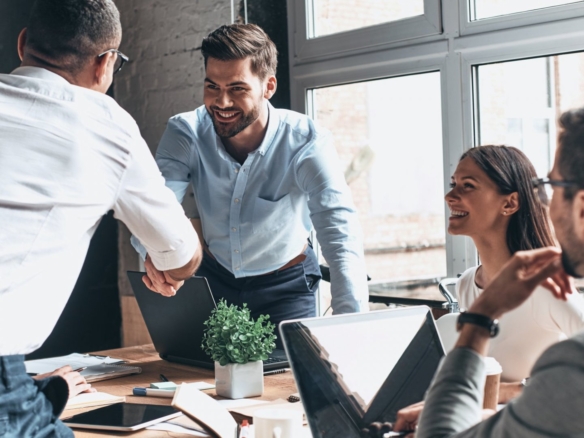 Two men engaged in a serious face-to-face business meeting, discussing real estate strategies.